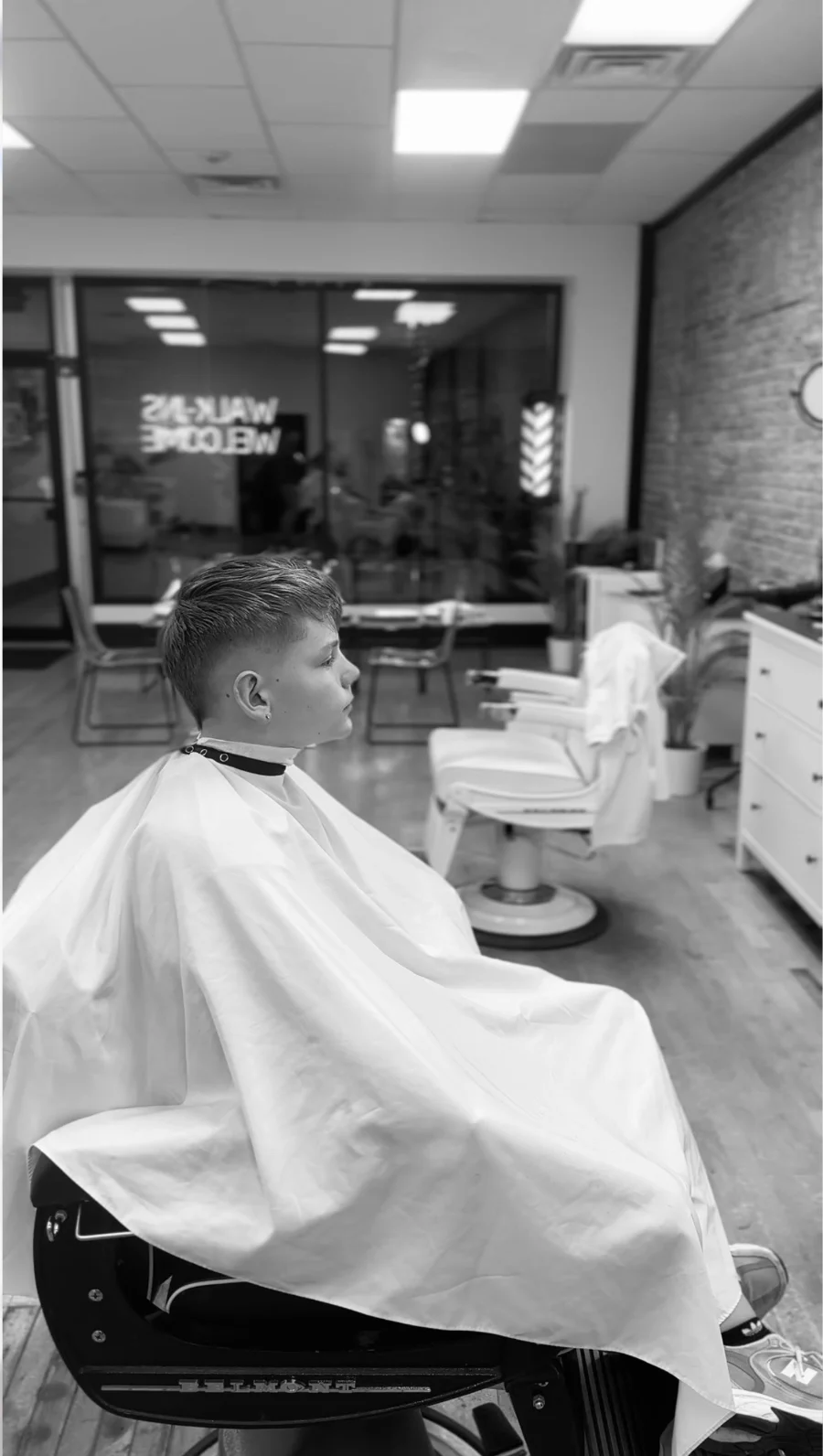 Young client in the barber chair at Clipper Artist